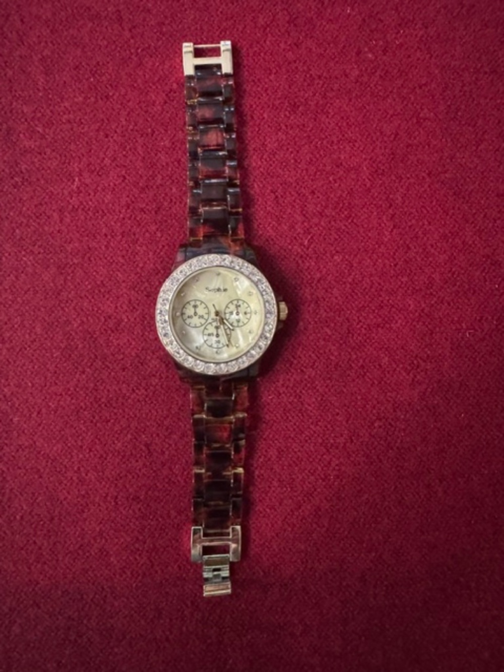 Sophie brand analog/gold-tone bezel set with rhinestones/tortoiseshell-pattern